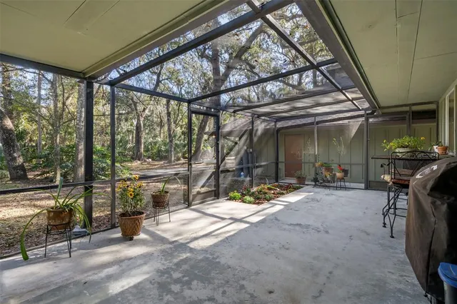 a backyard of a house with table and chairs