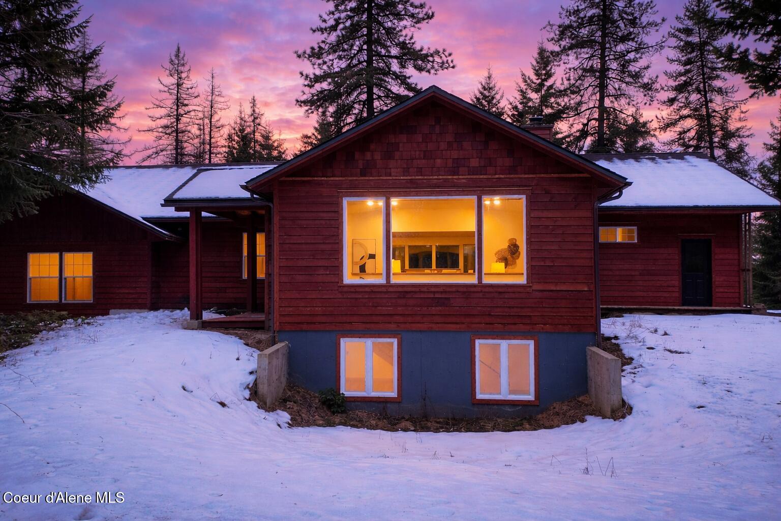 672 Hopkins Road Sandpoint, ID 83864 - Photo 2 of 72 Twilight cabin in snowy forest