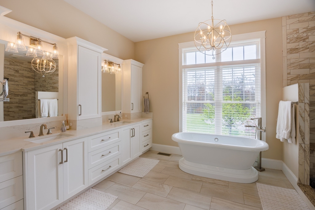 1776 Old Turnpike Road Oakham, MA 01068 - Photo 15 of 42 a spacious bathroom with a double vanity sink a large mirror and a bathtub