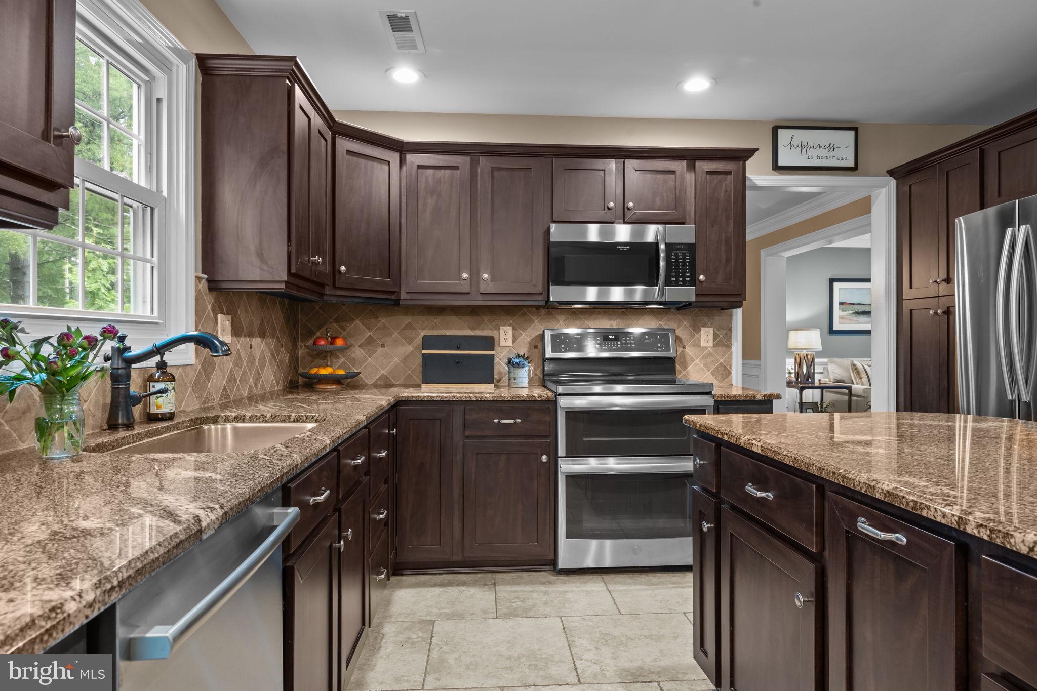 121 Beech Drive Hatboro, PA 19040 - Photo 14 of 46 a kitchen with stainless steel appliances granite countertop a sink stove and refrigerator
