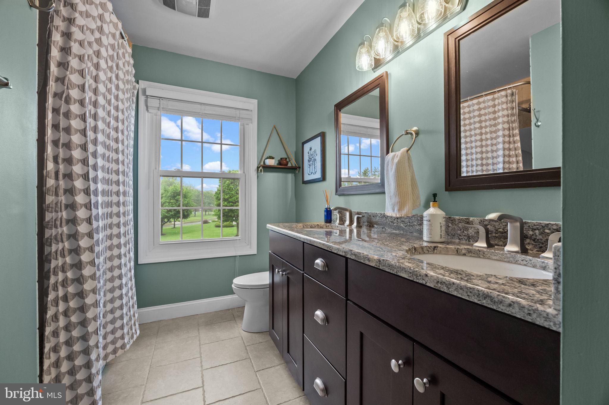 121 Beech Drive Hatboro, PA 19040 - Photo 24 of 46 a bathroom with a granite countertop sink a toilet a mirror and a window