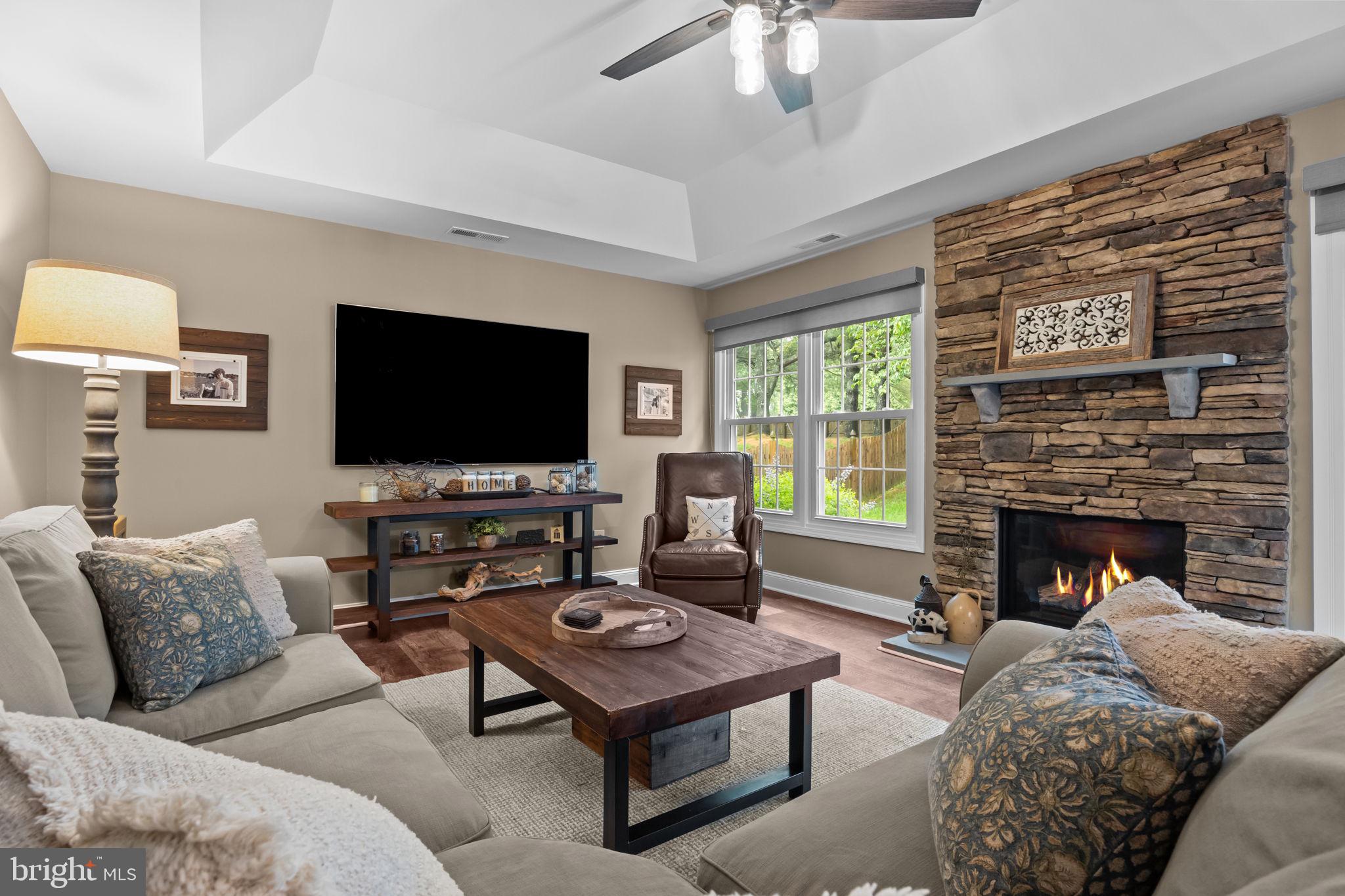 121 Beech Drive Hatboro, PA 19040 - Photo 8 of 46 a living room with furniture a flat screen tv and a fireplace
