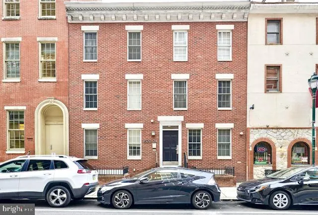 a car parked in front of a brick building