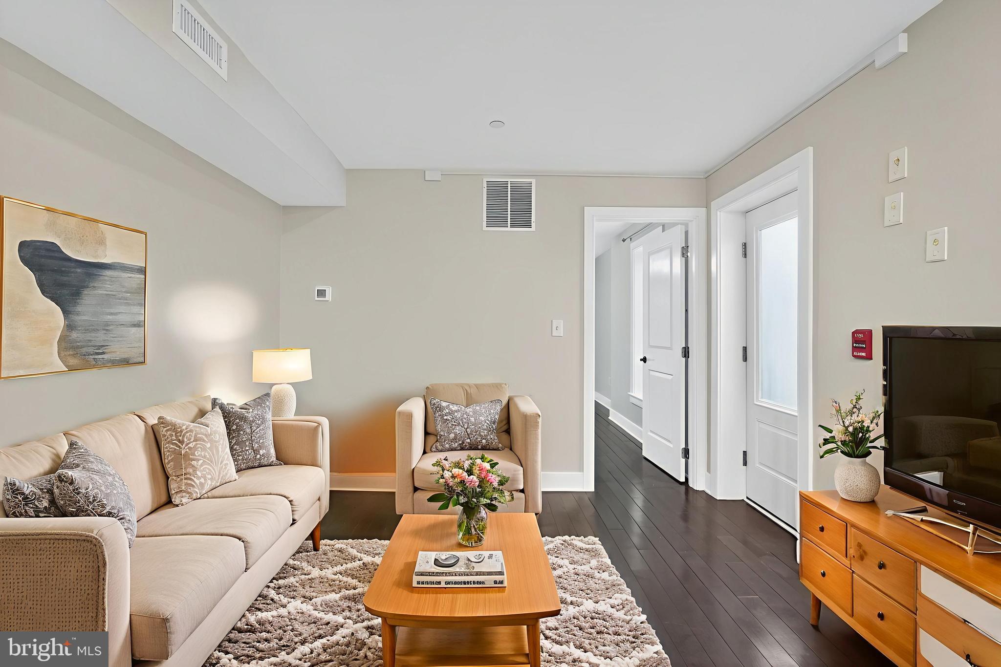 a living room with furniture and a flat screen tv