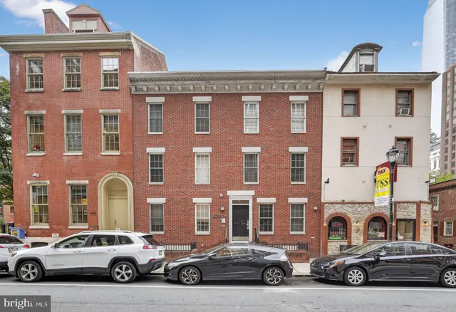 a view of a car parked in front of a building