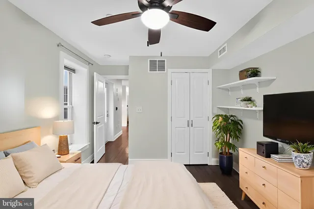 a bedroom with a bed and a flat screen tv