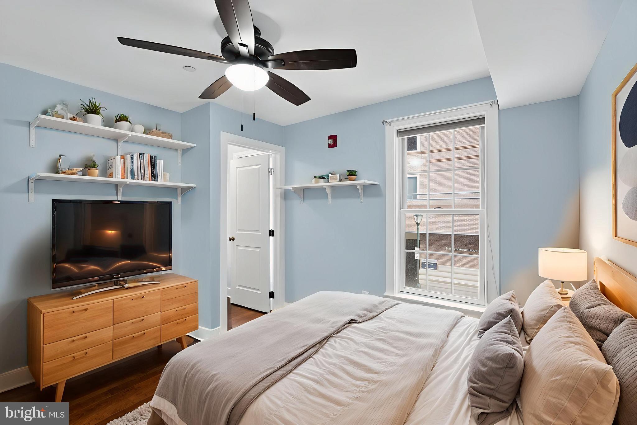 1522 Race Street, Unit 3 Philadelphia, PA 19102 - Photo 8 of 17 a bedroom with a bed and a television