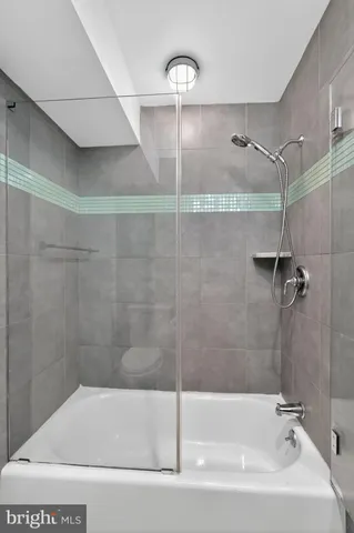 a bathroom with a bathtub and a shower
