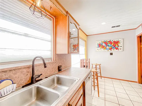 a kitchen with a sink a refrigerator and a window