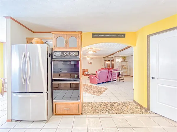 a kitchen with a refrigerator and a more cabinets