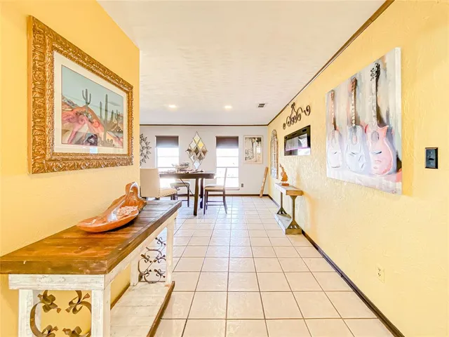 a hallway with a black white checkered floor next to a window