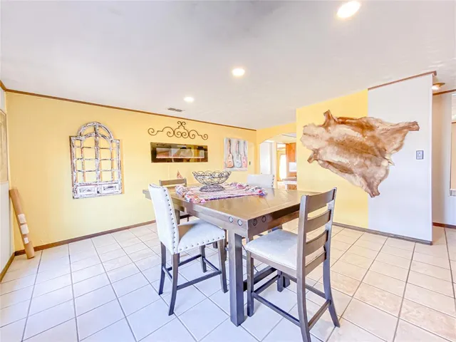 a view of a dining room with furniture and a window