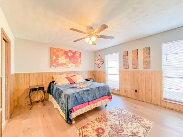 a bedroom with a bed and a window with outer view