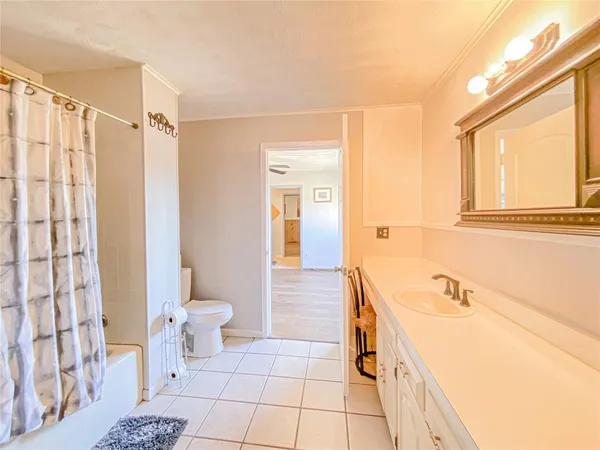 a spacious bathroom with a bathtub sink and toilet