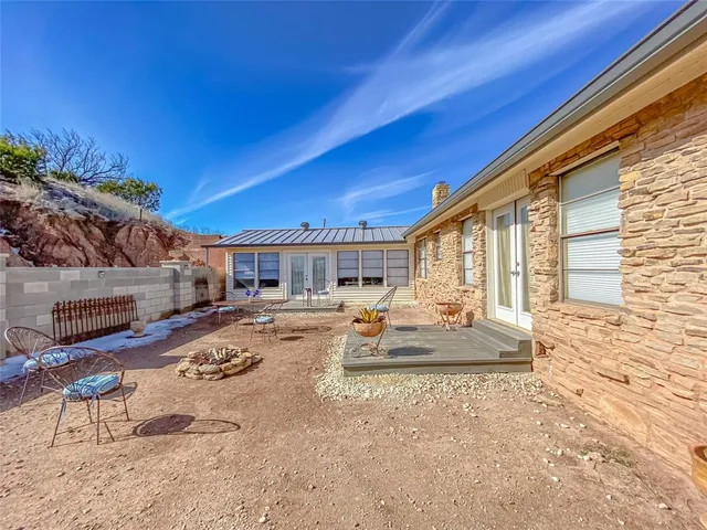 a view of a house with backyard and sitting area