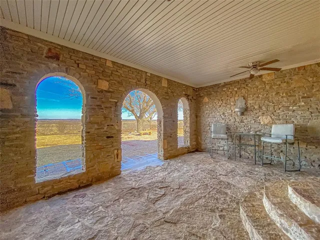 a view of empty room with fireplace and chandelier