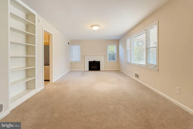 a view of a livingroom with an empty space and a window