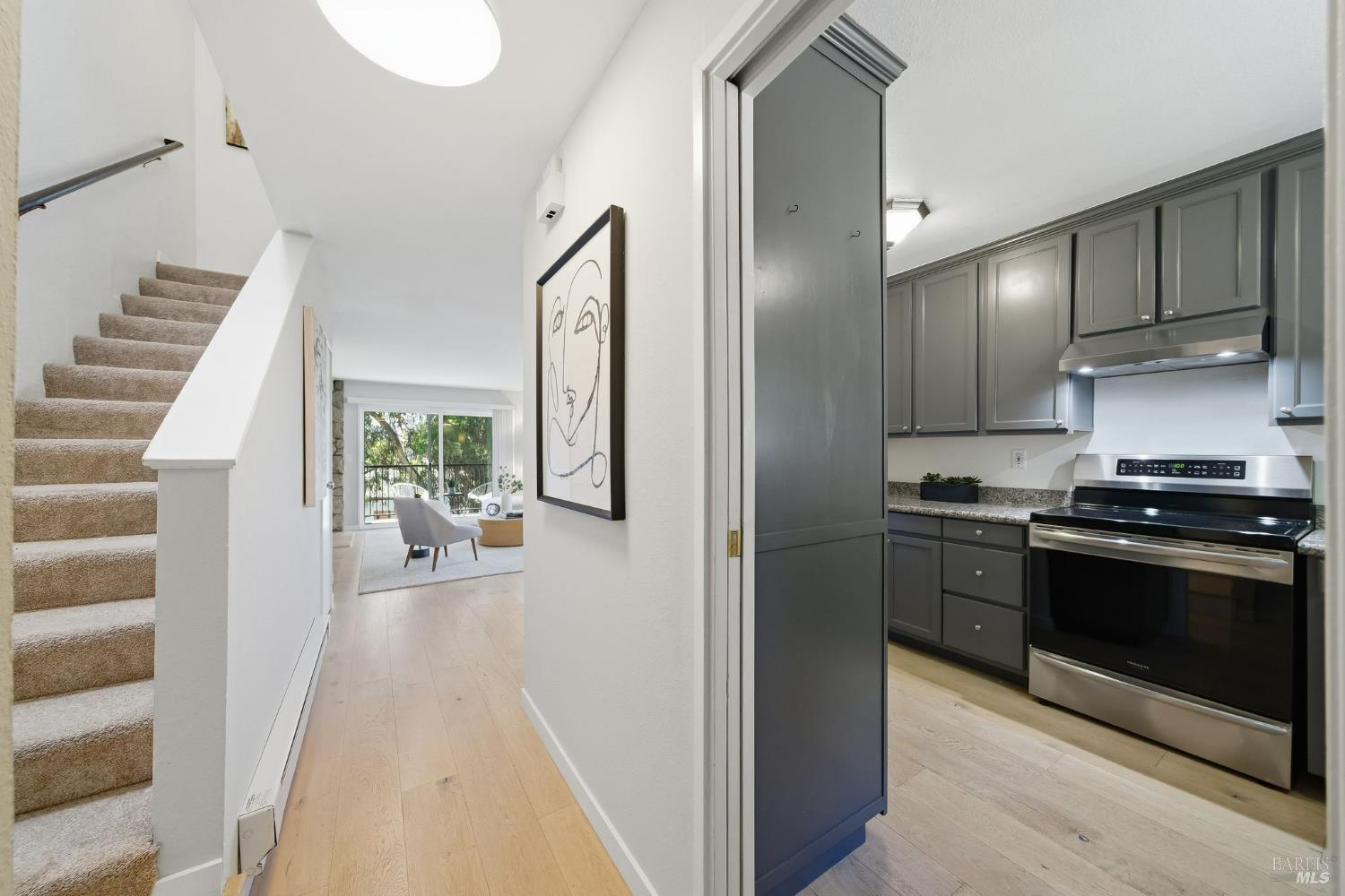 10 Professional Center Parkway, Unit 1 San Rafael, CA 94903 - Photo 15 of 35 a kitchen with a stove and a refrigerator with wooden floor