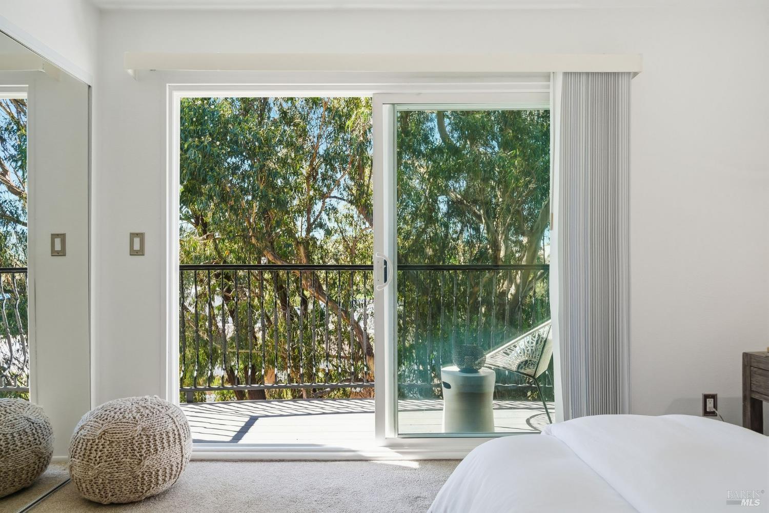 10 Professional Center Parkway, Unit 1 San Rafael, CA 94903 - Photo 19 of 35 a bedroom with a bed and glass door