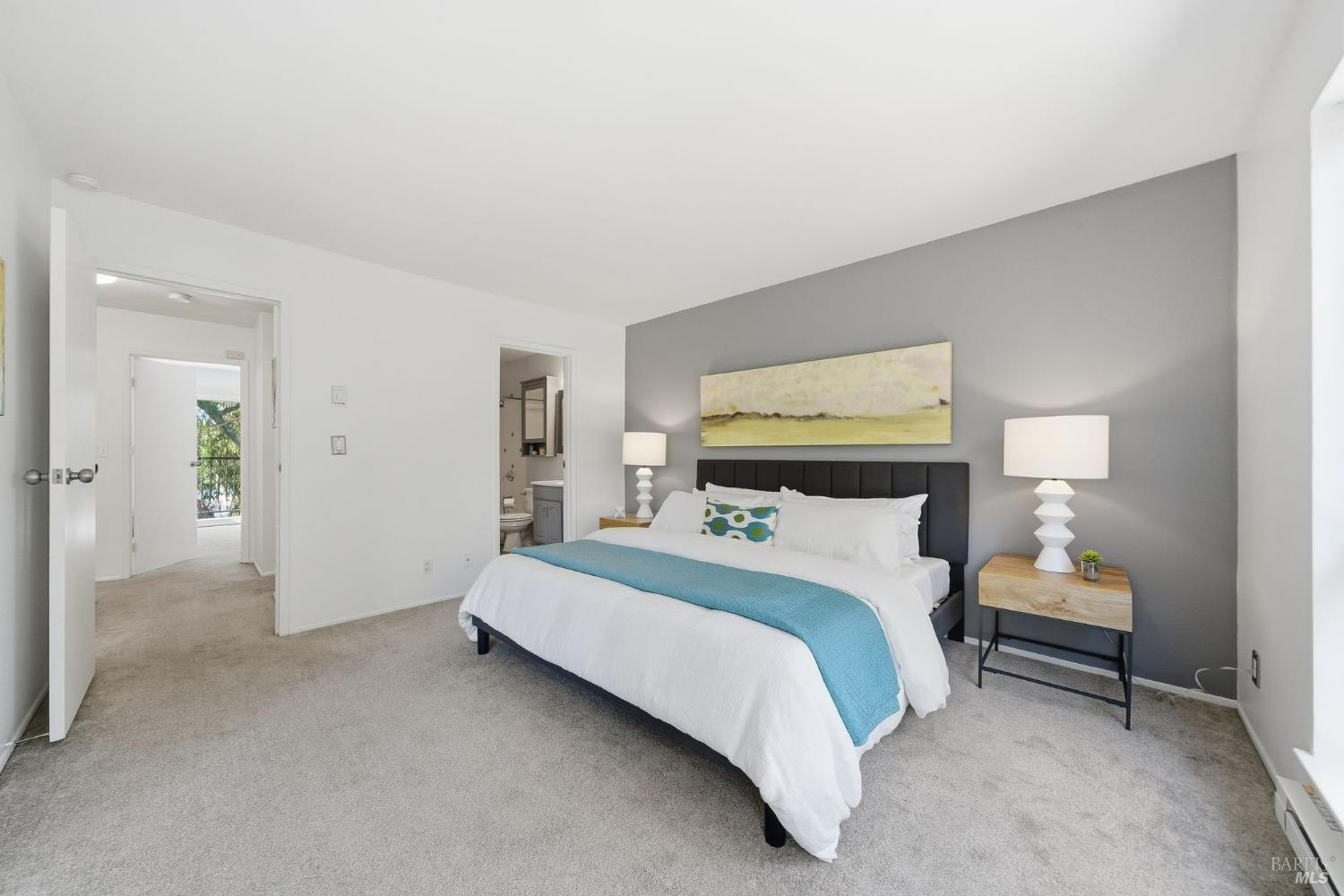 10 Professional Center Parkway, Unit 1 San Rafael, CA 94903 - Photo 24 of 35 a spacious bedroom with a bed and a lamp