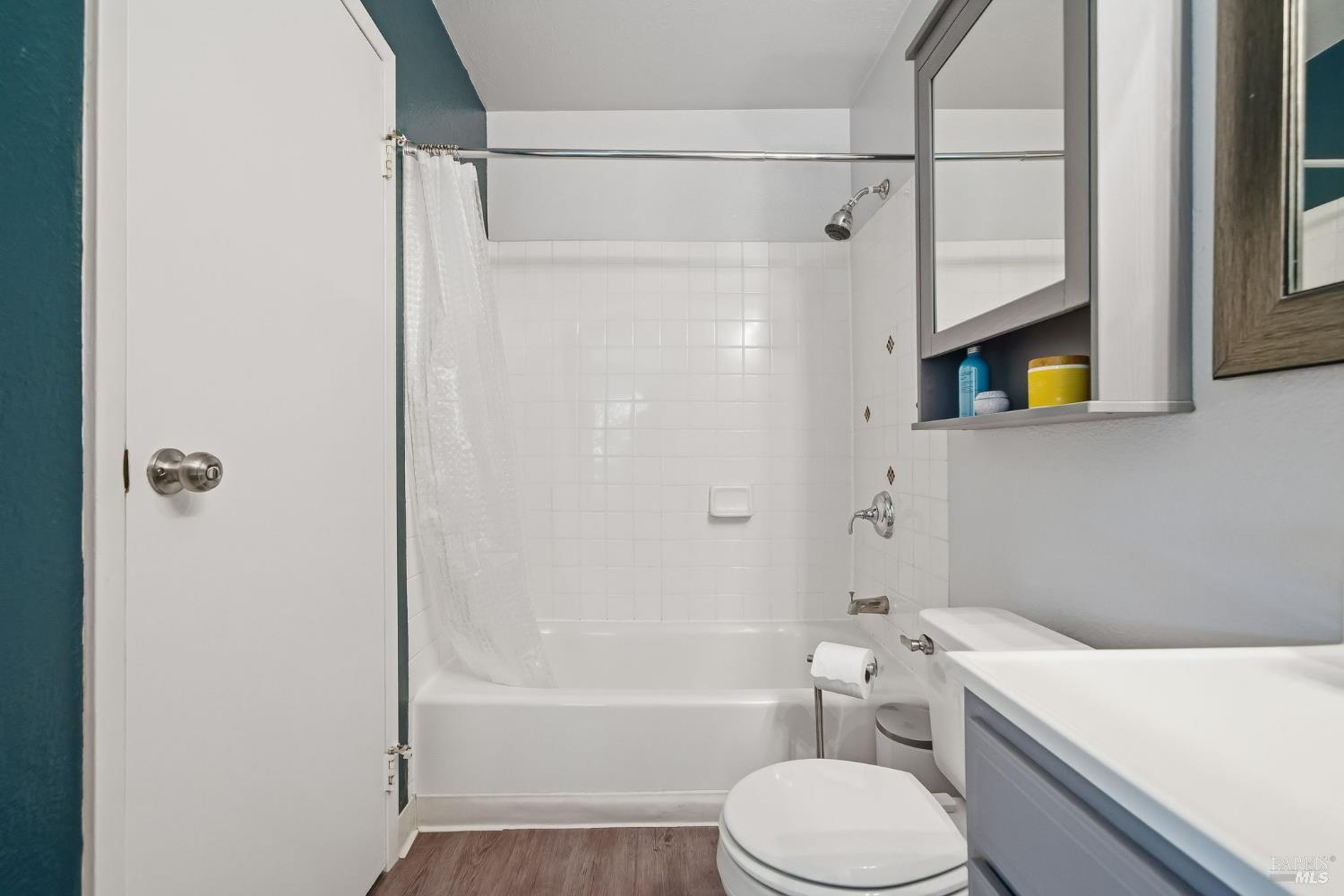 10 Professional Center Parkway, Unit 1 San Rafael, CA 94903 - Photo 27 of 35 a white toilet sitting next to a bath tub shower