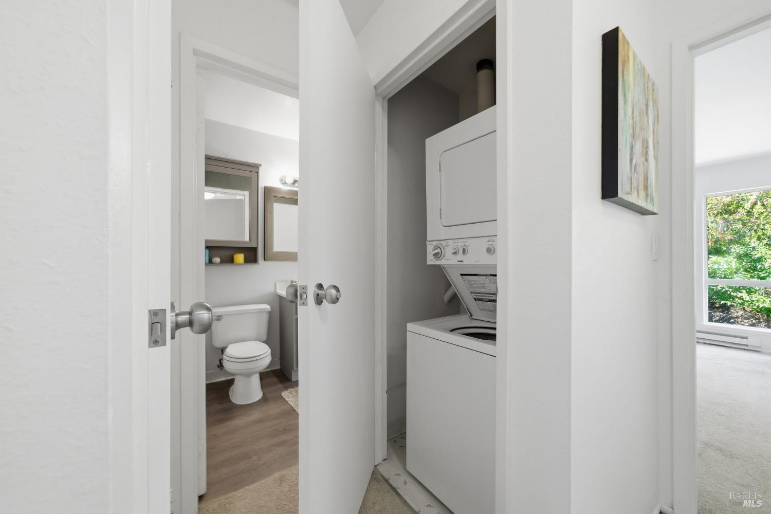 10 Professional Center Parkway, Unit 1 San Rafael, CA 94903 - Photo 28 of 35 a bathroom with a toilet sink and mirror