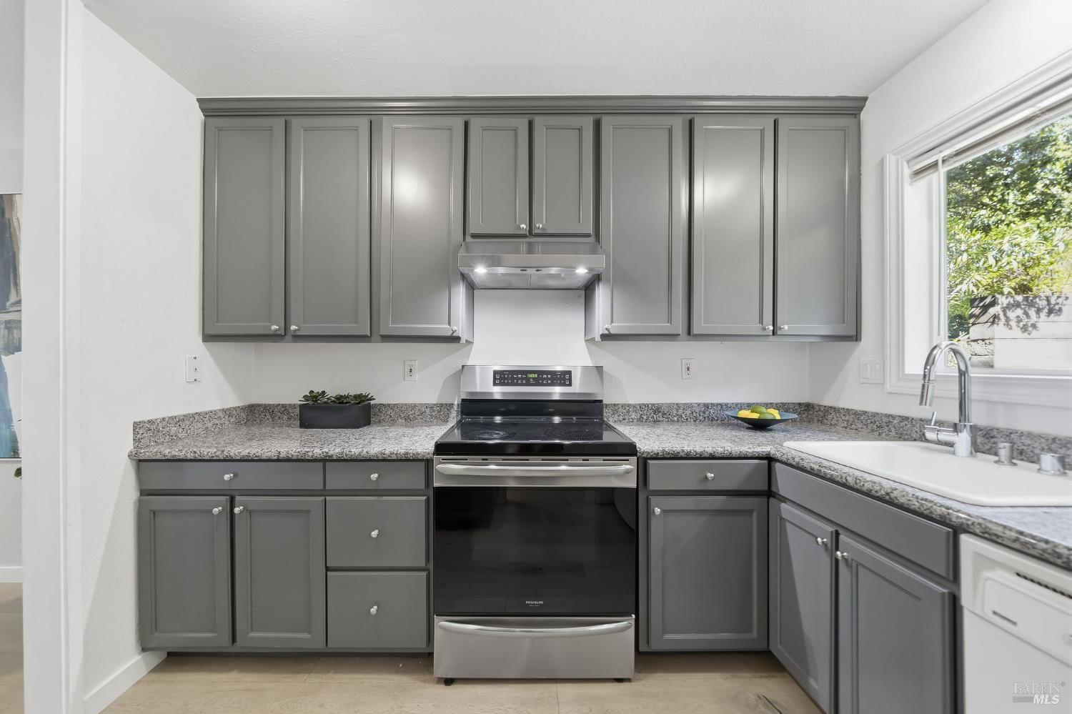 10 Professional Center Parkway, Unit 1 San Rafael, CA 94903 - Photo 10 of 35 a kitchen with stainless steel appliances granite countertop white cabinets stove top oven and sink