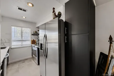 a kitchen with stainless steel appliances a refrigerator and a sink
