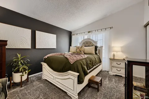 a bedroom with a bed and a potted plant