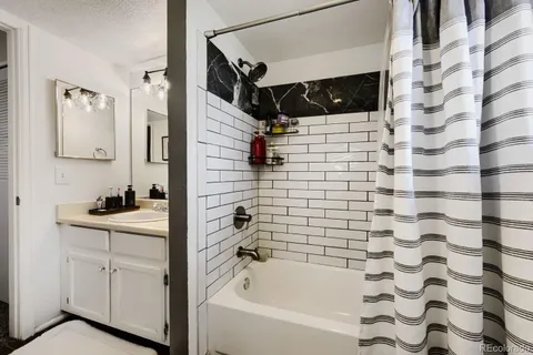 a bathroom with a bathtub and shower