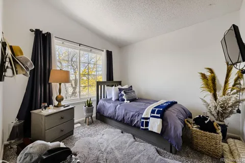 a bed room with a bed and a window