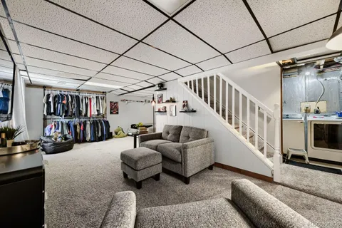 a living room with furniture and stairs