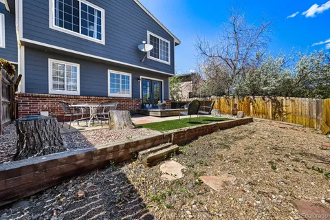 a view of a house with backyard and sitting area