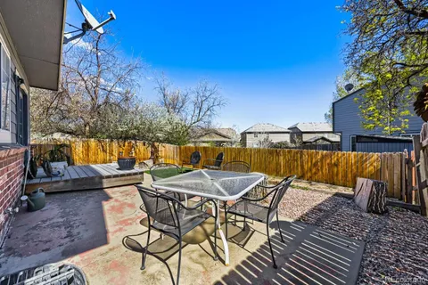 a view of patio with table and chairs and potted plants