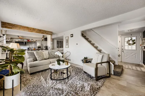 a living room with furniture and wooden floor