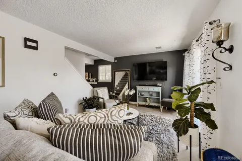 a bedroom with furniture and a flat screen tv