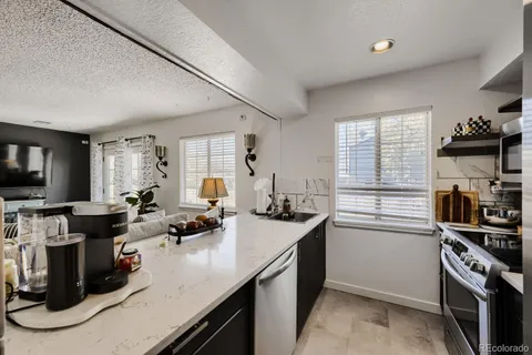 a kitchen that has a sink and a stove in it