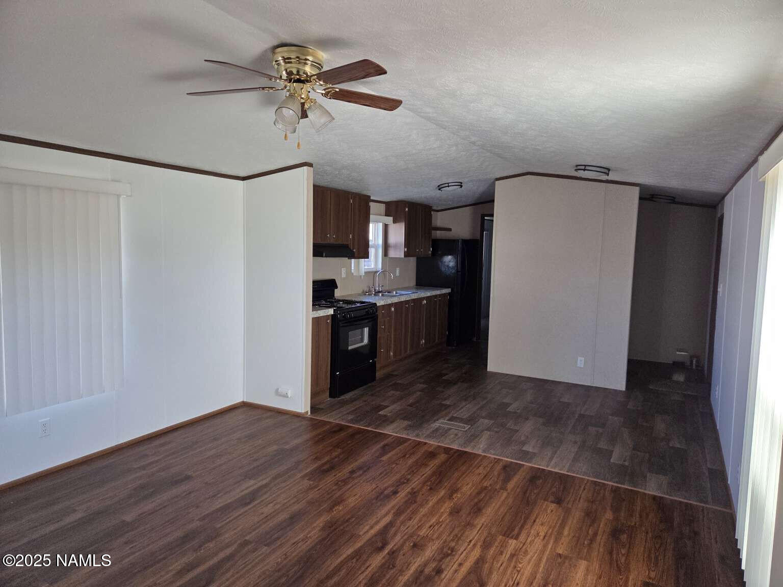 22 Sunset Street, Unit 22 Page, AZ 86040 - Photo 4 of 6 a view of a kitchen with a sink and a refrigerator