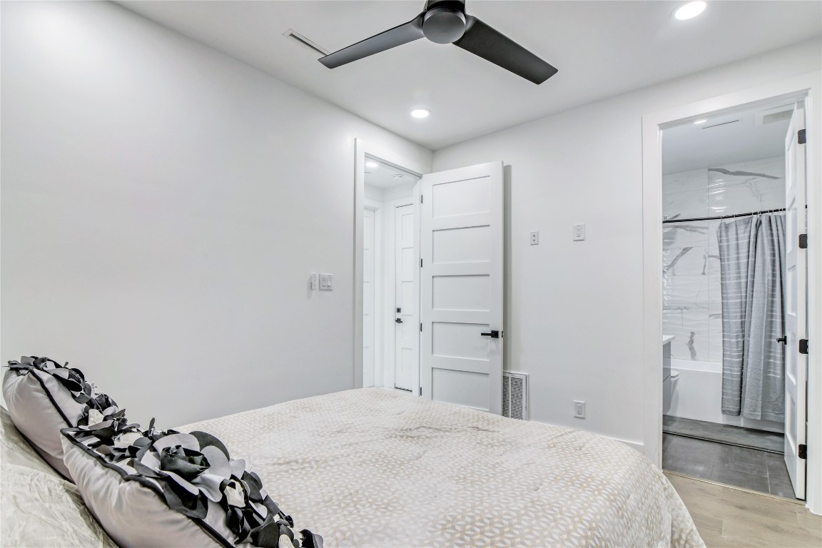 1406 Fairview Street Houston, TX 77006 - Photo 15 of 34 a bedroom with a bed and a chandelier