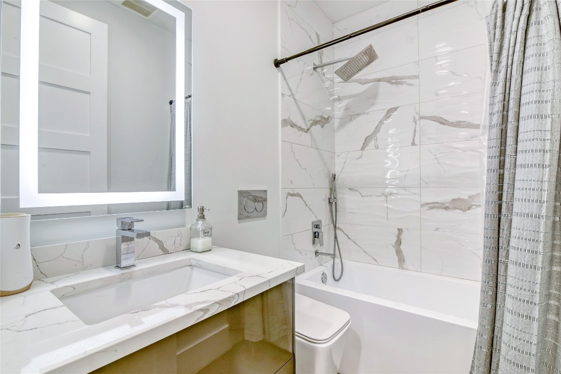 1406 Fairview Street Houston, TX 77006 - Photo 16 of 34 a bathroom with a granite countertop sink toilet and shower