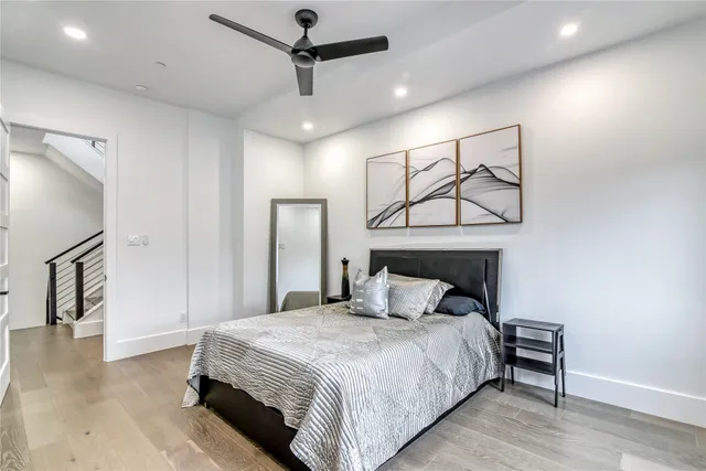 a bedroom with a large bed and a chandelier