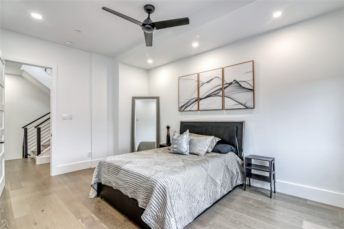 1406 Fairview Street Houston, TX 77006 - Photo 17 of 34 a bedroom with a bed and a chandelier