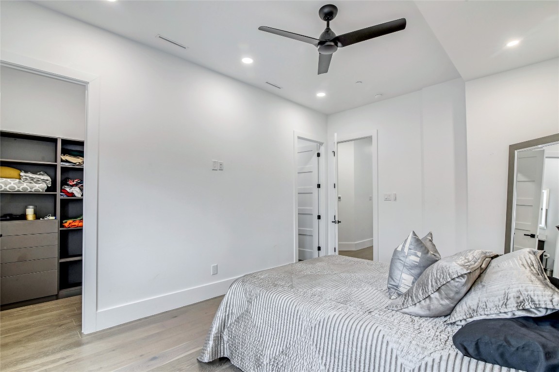 1406 Fairview Street Houston, TX 77006 - Photo 18 of 34 a bedroom with a large bed and a chandelier