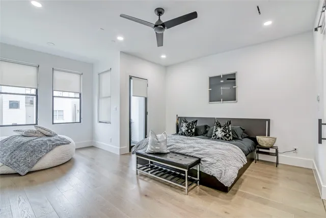 a bedroom with a bed window and a flat screen tv