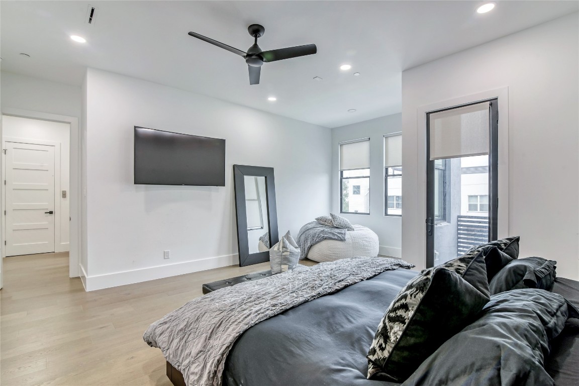 1406 Fairview Street Houston, TX 77006 - Photo 22 of 34 a bedroom with a bed window and a flat screen tv