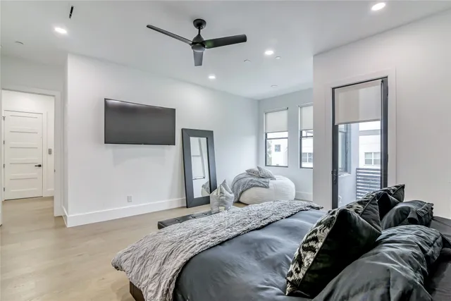 a view of a bedroom with a bed and a window