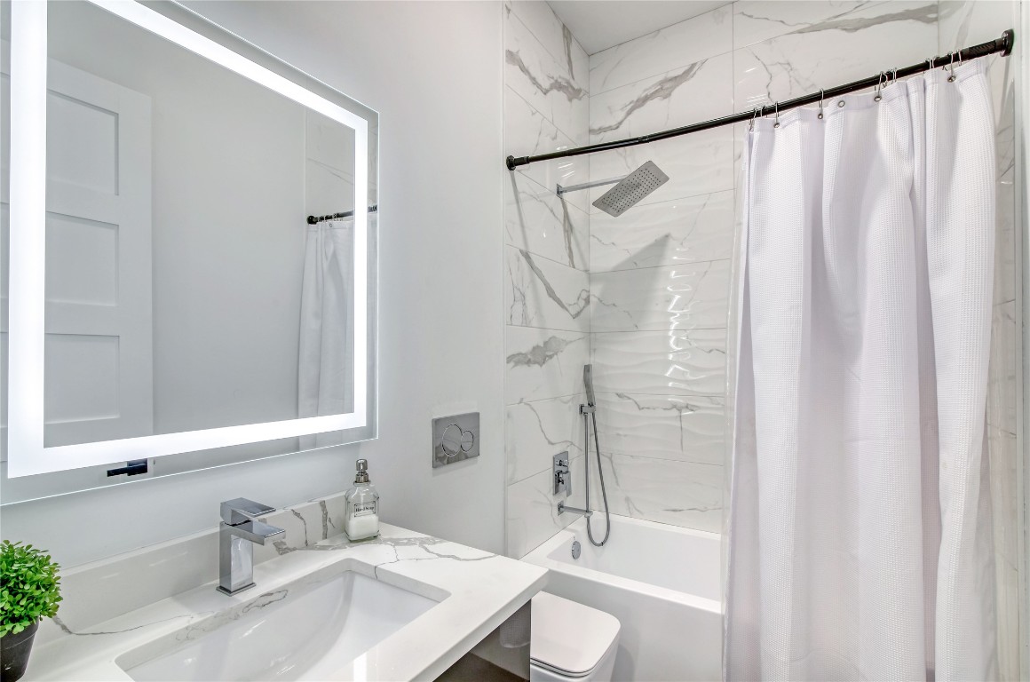 1406 Fairview Street Houston, TX 77006 - Photo 28 of 34 a bathroom with a granite countertop sink toilet and shower