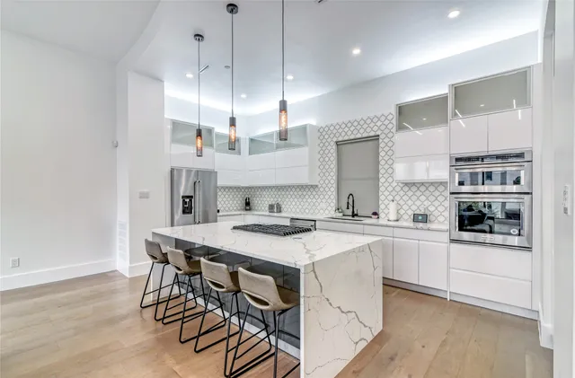 a kitchen with stainless steel appliances granite countertop a sink stove and refrigerator