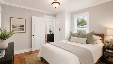 a bedroom with a bed a chandelier and a window