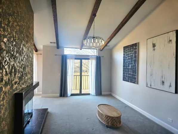 a view of a hallway and a livingroom with a bathroom